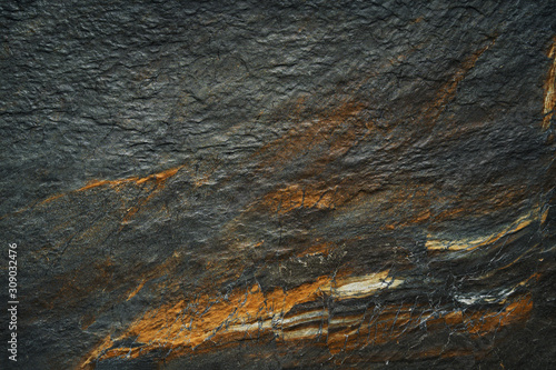 A dark abstract golden gray ore mineral Texture background