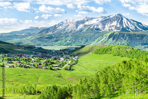 Crested Butte, Colorado town cityscape high angle view from Snodgrass hiking trail in summer with alpine meadows and aspent trees forest grove photo