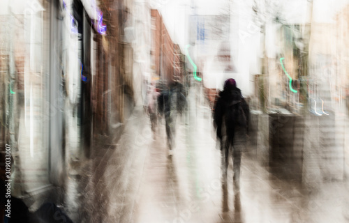 Long exposure of people on the high street taken with intentional camera shake to introduce an impressionistic effect and light trails © Matthew