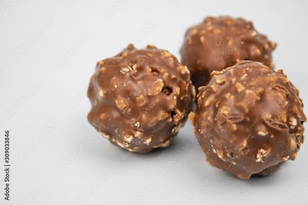 Candies. Chocolate candies with nuts. on a light background. copyspace Candies. Chocolate candies with nuts. on a light background. copyspace