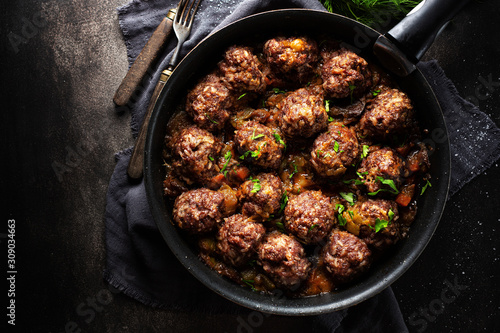 Fried meatballs with sauce on pan photo