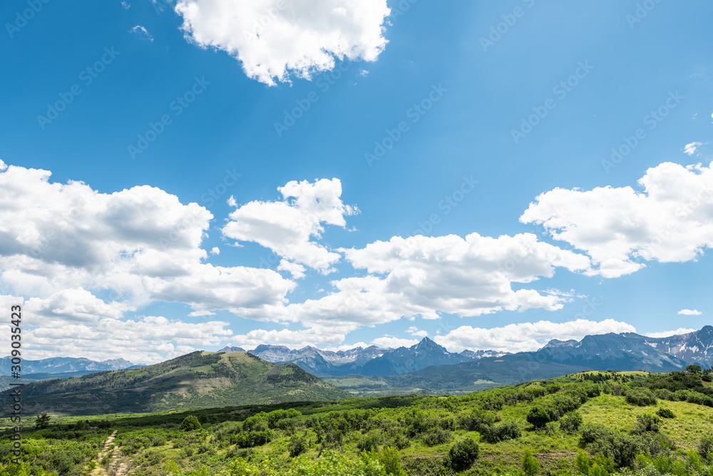Wide angle panoramic view of blue sky near Ouray, Colorado highway scenic road 550 San Juan rocky mountains range with green meadow in summer Wide angle panoramic view of blue sky near Ouray, Colorado highway scenic road 550 San Juan rocky mountains range with green meadow in summer