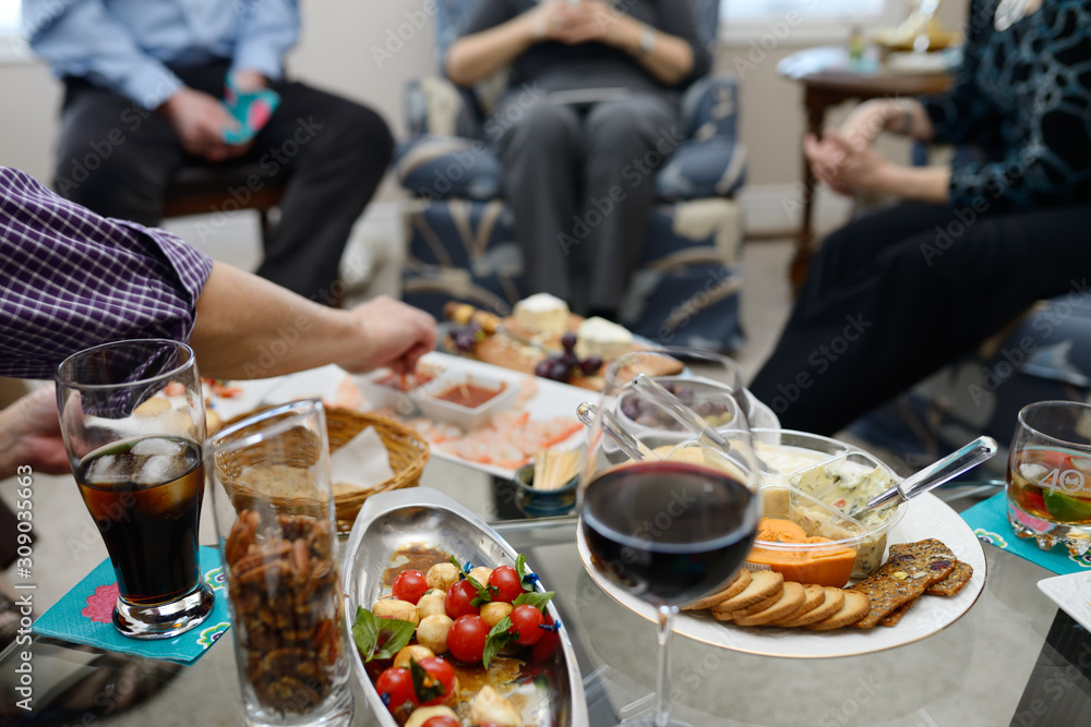 Group of friends enjoying appetizers before a dinner party Group of friends enjoying appetizers before a dinner party
