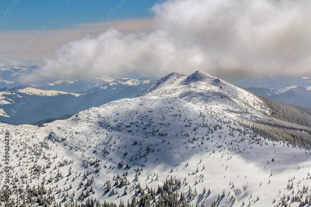 Winter landscape panorama. Snow cowered mountains after snowfall.