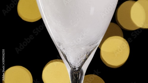 champagne in a glass, concept of new year and Christmas champagne pouring in a glass dark background with beautiful yellowbokeh. champagne pour into a glass. Close up shot. Slow motion photo