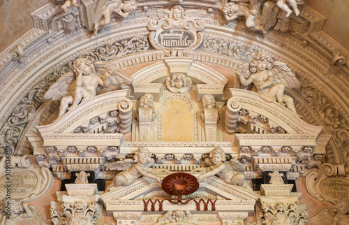 OSSUCCIO, ITALY - MAY 12, 2015: The detail of from baroque side altar in church Chiesa dei Santi Eufemia e Vicenzo.