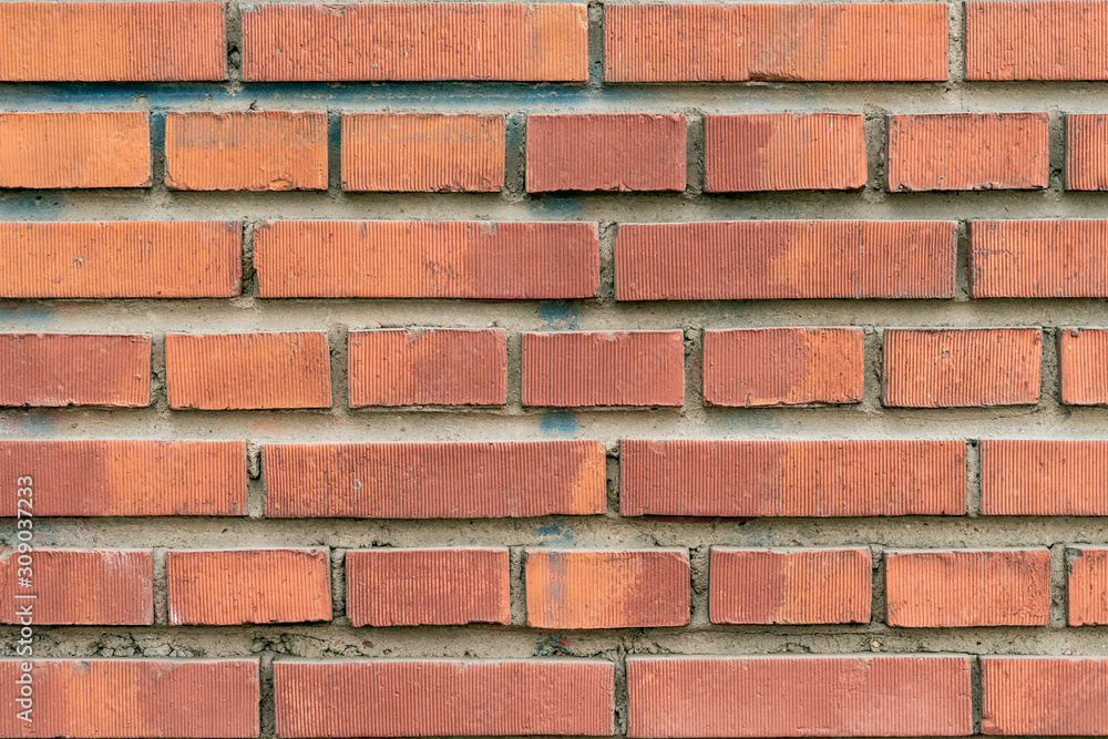 Obraz premium Wall texture of modern brown rough brick. Cross brickwork. Grunge surface background. Vintage orange brickwall.