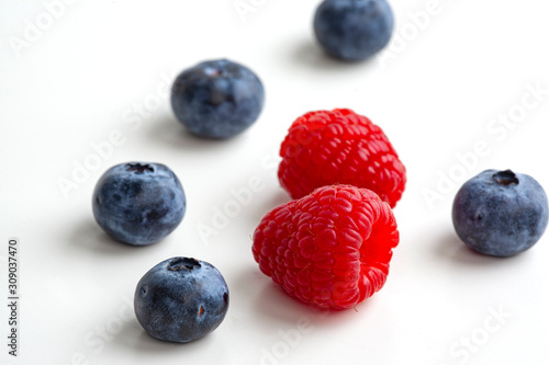 blueberries and raspberries isolated on white background