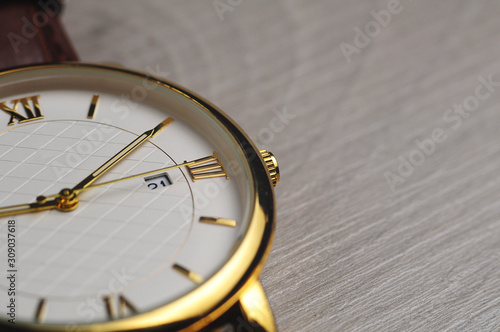 Close up macro watch on grey wooden board (ID: 309037618)
