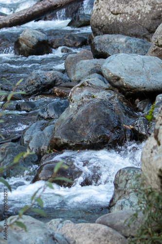 large rocks sticking out of blue river rapids