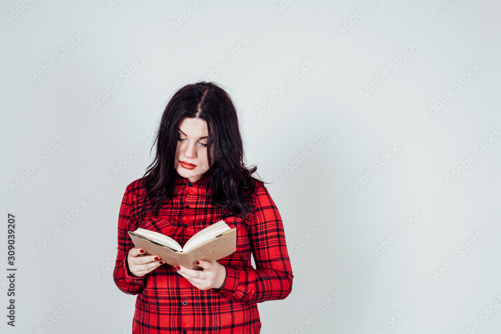 fat girl in a red shirt reads a book fat girl in a red shirt reads a book