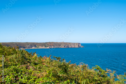 ride on the GR34 in Brittany with far off Cape Frehel and its lighthouse