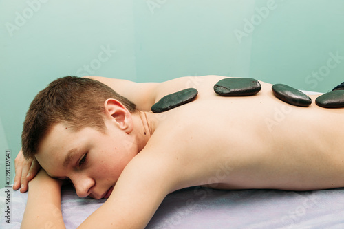 stone massage man getting stone therapy massage at the cabinet