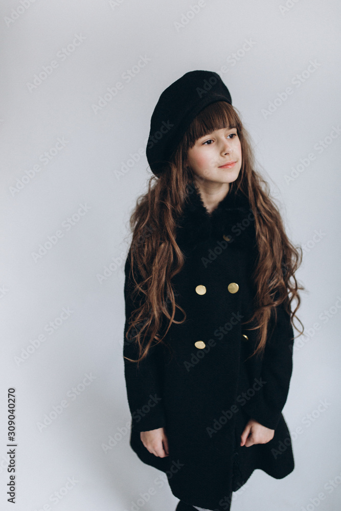 Fototapeta premium Close up portrait of little cute adorable girl posing alone on isolated white background in studio. Childhood, fashion kids, baby model concept