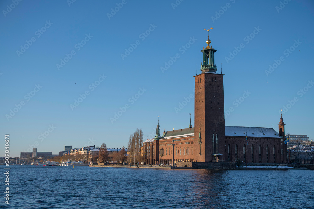 Water view over Stockholm Town City Hall a snowy and sunny Nobel price day.