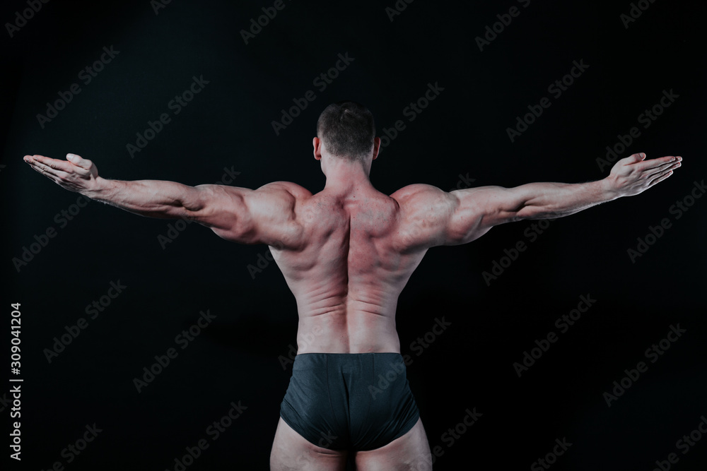 the athlete bodybuilder shows his muscles after sports the athlete bodybuilder shows his muscles after sports