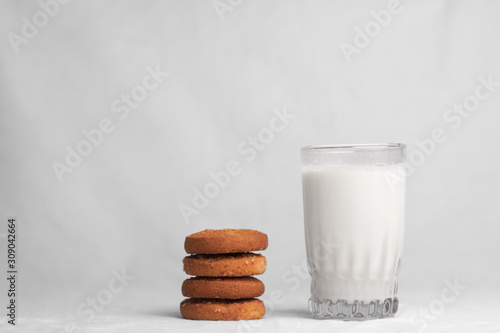 cookies and glass of milk on white background