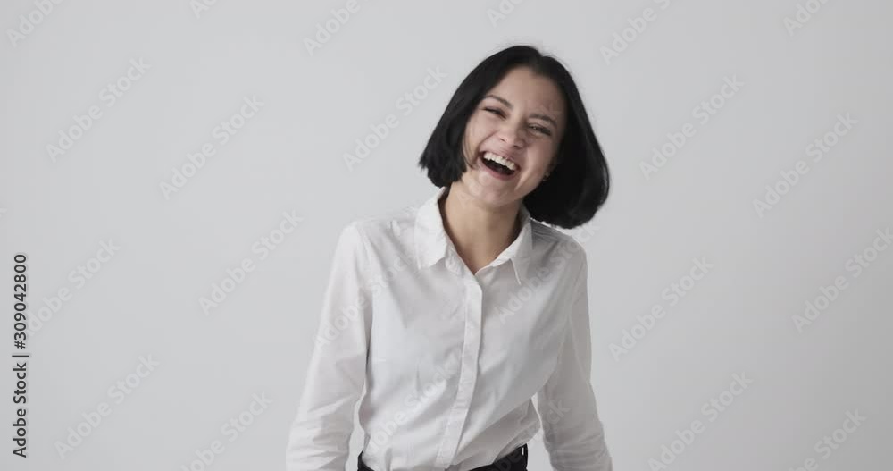 Excited young woman laughing over white background Excited young woman laughing over white background