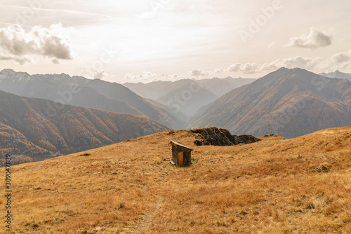 Wooden Hut in mountain scenery Dolomites with grass and trees