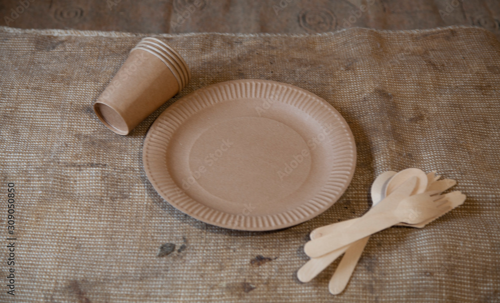 Eco paper utensils with cardboard, paper, wood. On an old wooden table, concept of zero plastic. Eco paper utensils with cardboard, paper, wood. On an old wooden table, concept of zero plastic.