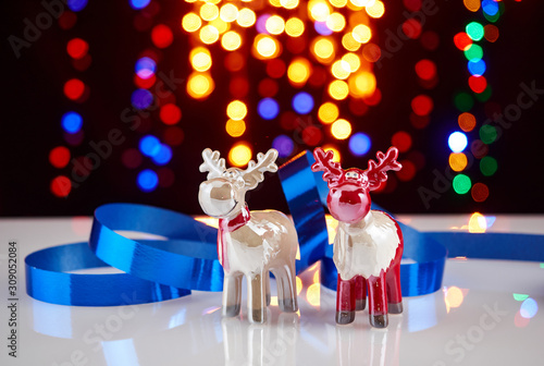 Christmas toy reindeer.On the background of colored lights.
