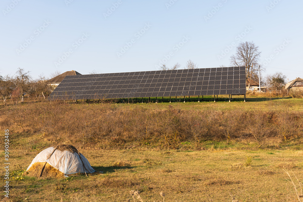 Autumn photo of the solar panels among the meadow