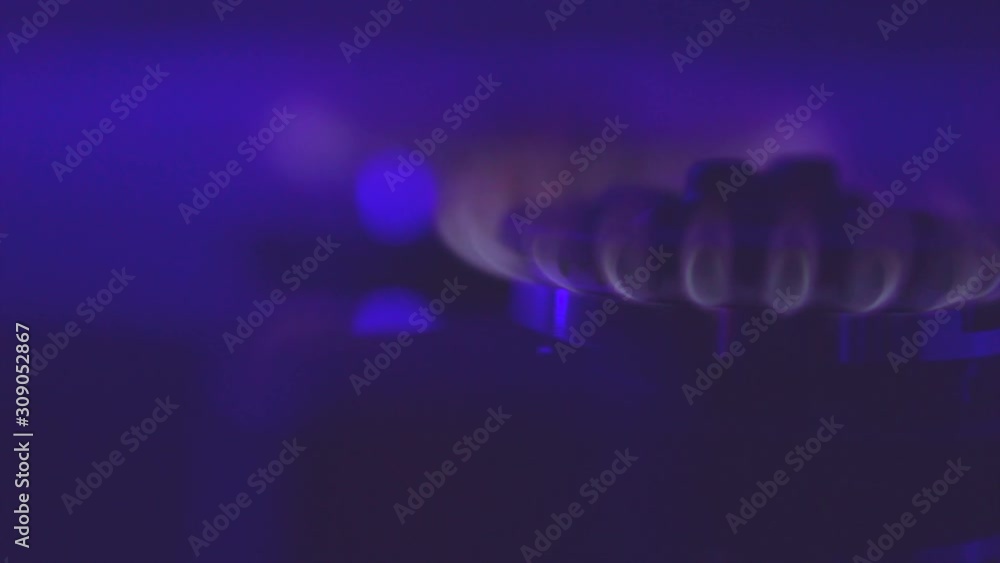 Gas blue flame. Gas stove on black background. Closeup of burning