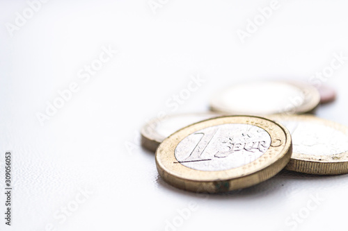 Several euro coins on light blurred background. Closeup photo