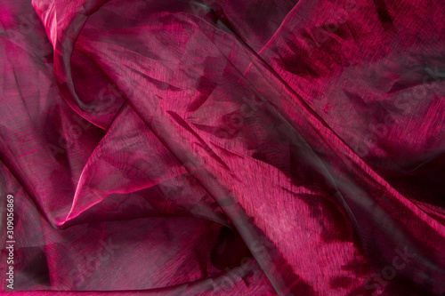 Background fabric folds lilac pink tulle or organza, selective focus