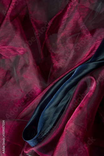 Background fabric folds lilac pink and dark blue tulle or organza, selective focus © Sahaidachnyi Roman