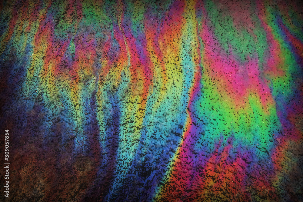 Puddle of water with gasoline-rainbow abstraction