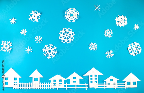 Christmas theme figures made of white paper on blue background © gorvik