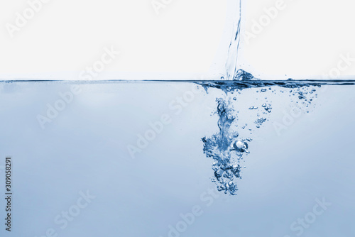 clean water drop pouring stream with bubbles, blue clean environment, isolated