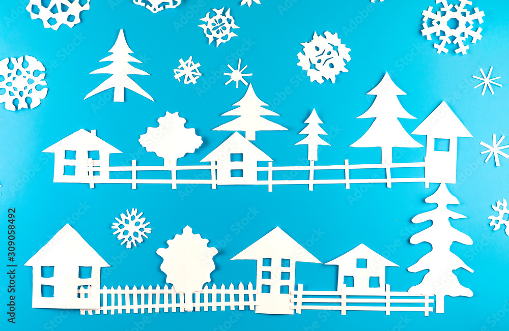 Christmas theme figures made of white paper on blue background Christmas theme figures made of white paper on blue background