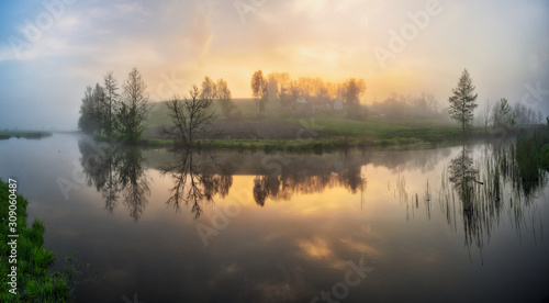 fog in the river valley. picturesque spring morning. beautiful foggy sunrise in a foggy meadow © sergnester