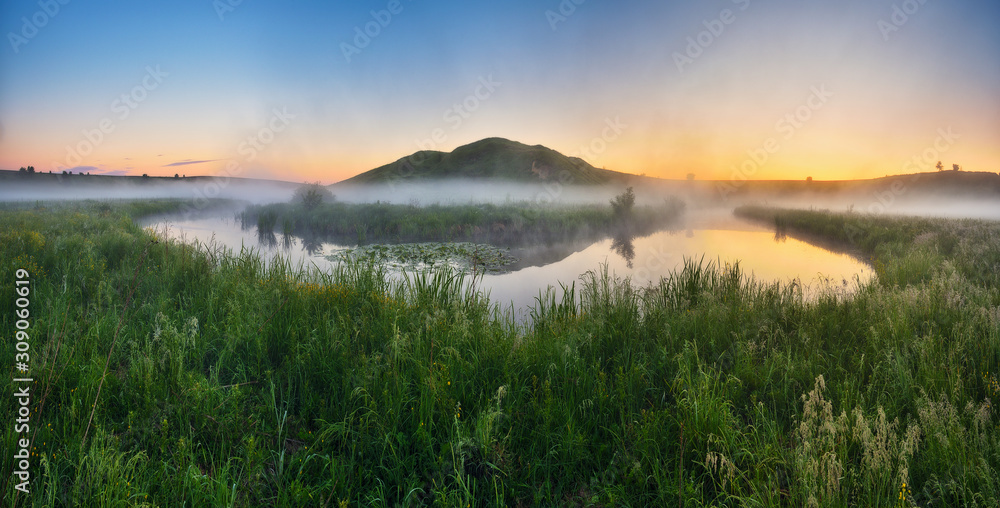 fog in the river valley. picturesque spring morning. beautiful foggy sunrise in a foggy meadow