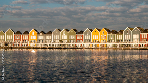 Colorful houses on the waterside (Rietplas) of the village Houten in the Netherlands.