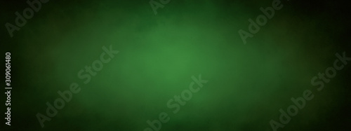green Christmas background banner with black border and grunge metal texture design and soft center lighting