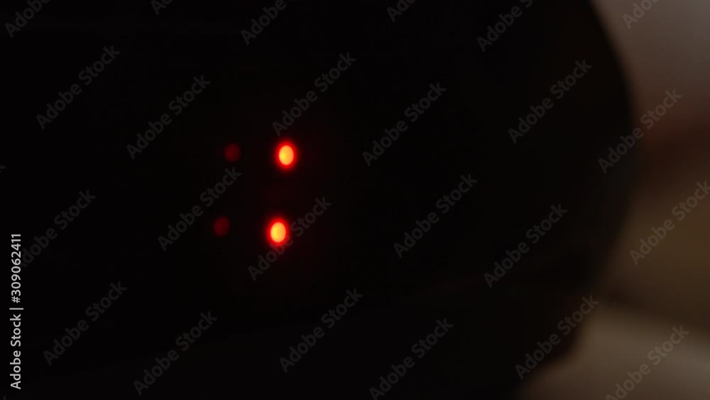 Close-up of black digital clock screen showing 3.00. Blinking red ...