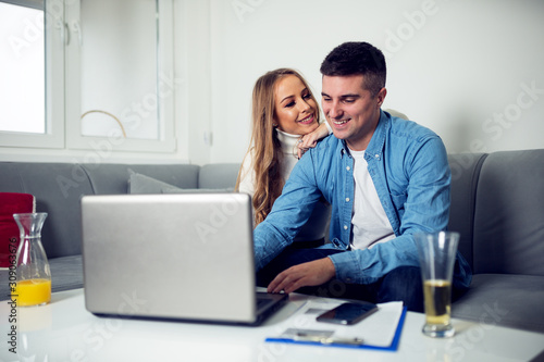 Couple in home using laptop