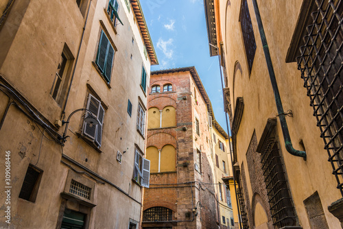 Narrow streets of Lucca ancient town with traditional architecture, Italy