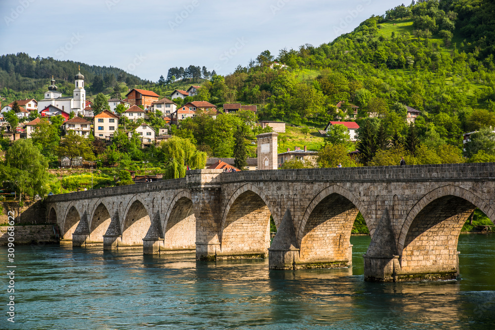 View on the Mehmed Pasa Sokolovic Bridge over the river Drina, and the town of Visegrad, Bosnia and Herzegovina