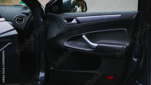 Control panel in the car door. Car door handle with adjustment knobs.