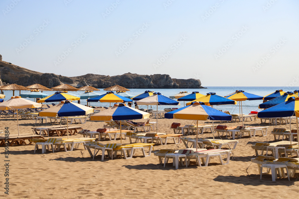 The sea coast, beach chairs and umbrellas from the sun.