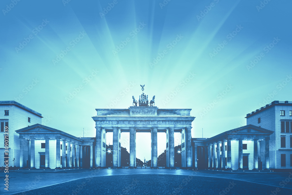 Obraz premium Illuminated Brandenburg Gate (Brandenburger Tor) in Berlin, Germany, at night. Monochrome image toned trendy classic blue, color of the year 2020.