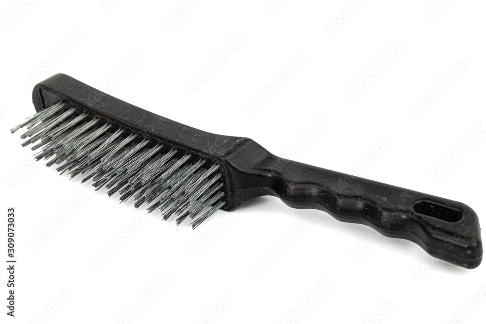 Steel wire brush with handle from black plastic for cleaning and polishing hard or metal equipment, isolated on white background Steel wire brush with handle from black plastic for cleaning and polishing hard or metal equipment, isolated on white background