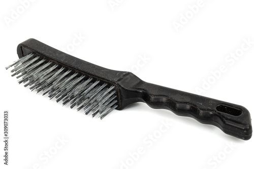 Steel wire brush with handle from black plastic for cleaning and polishing hard or metal equipment, isolated on white background