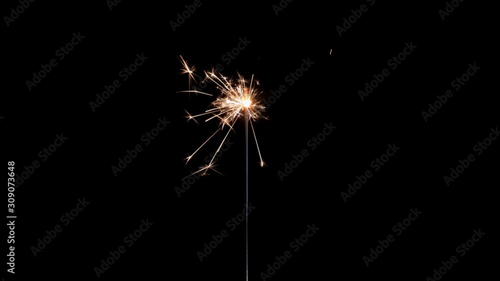 Sparkler on black background . Gun powder sparks shot against deep dark background. Burning fuse or bengal fire Isolated. Lightening Christmas sparkler. Sparkler on black background . Gun powder sparks shot against deep dark background. Burning fuse or bengal fire Isolated. Lightening Christmas sparkler.
