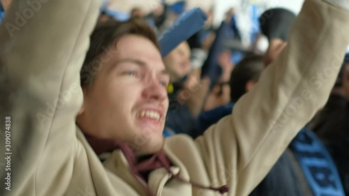 People with crowd hockey game cheering winning team. Portrait spectator power hockey match fun goal win closeup happy fan emotion scream background crowd 4K. Fan man shouting happy goal favorite game. photo