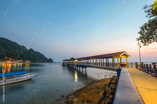 Pulau Perhentian, Terengganu - August 14th, 2018  : Beautiful view of small Perhentian Island with multiple boats during blue hour. Image contains noise and soft focus photo